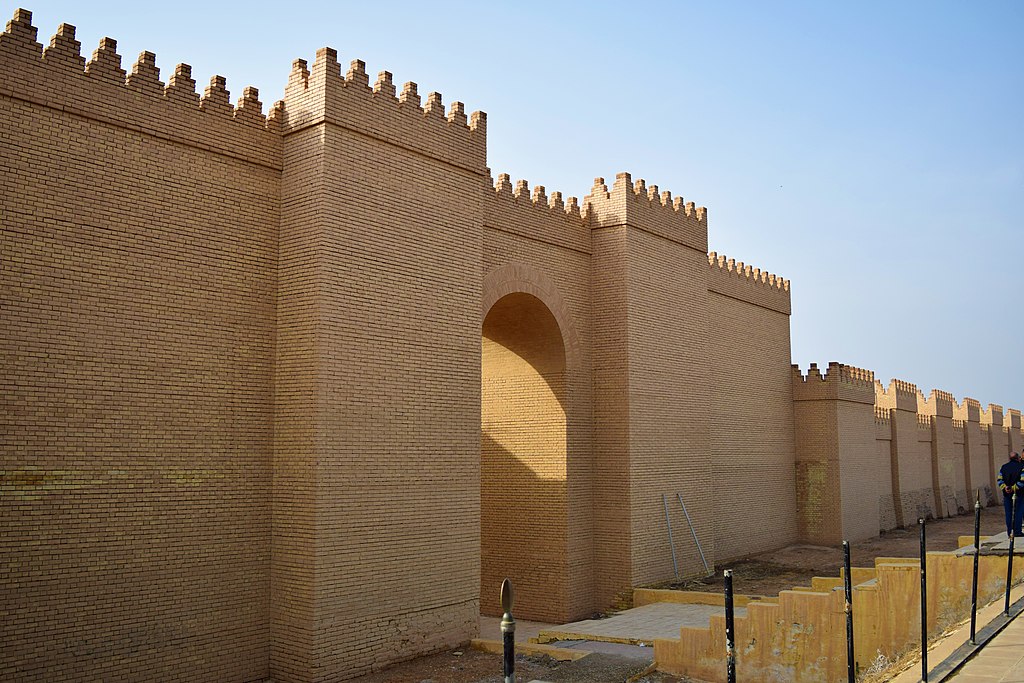 Image Illustrating the archaeological site of Babylon in Iraq. A reconstructed Neo-Babylonian external wall and gate appears