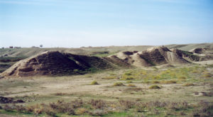 image illustrating the archaeological ruins of ashur in iraq. indistinct remains of mudbrick work appear in the image
