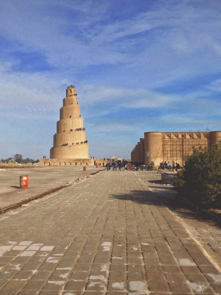 Image illustrating the Samarra Malwiya minaret, Iraq, in the background. other heritage buildings appear nearby